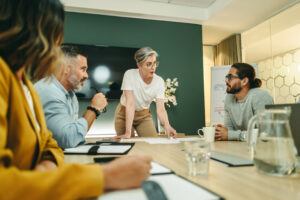 four modern professionals gathered around a conference table