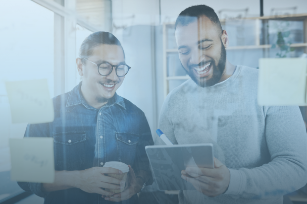 two employees looking at an ipad