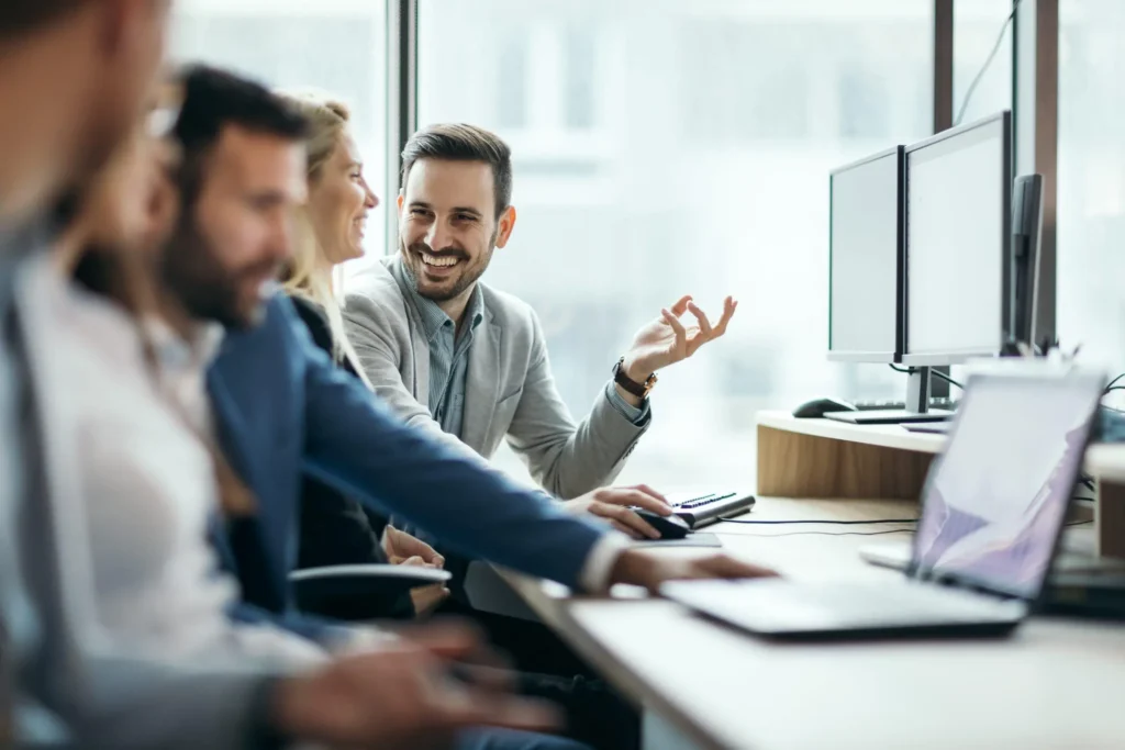 Cheerful businessman working with colleagues