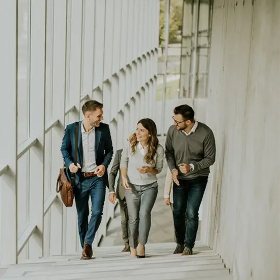 three young professionals walking up a set of office stairs