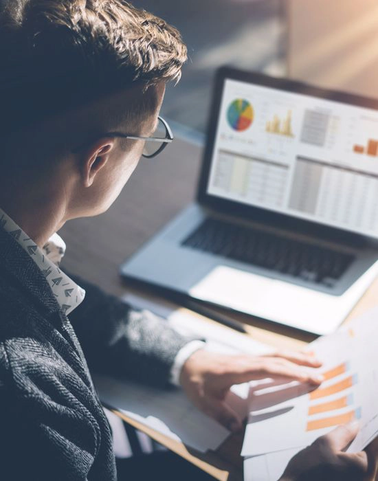 professional reviewing data on a computer