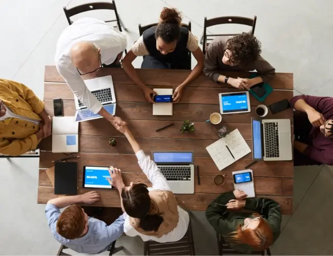 aerial shot of table full of professionals workgin together