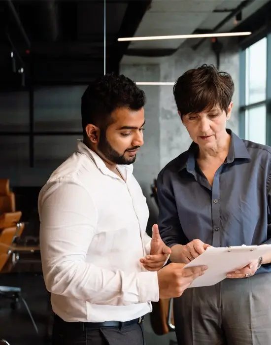 two professionals reviewing a document together